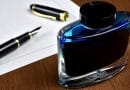 fountain pen with an ink bottle and paper